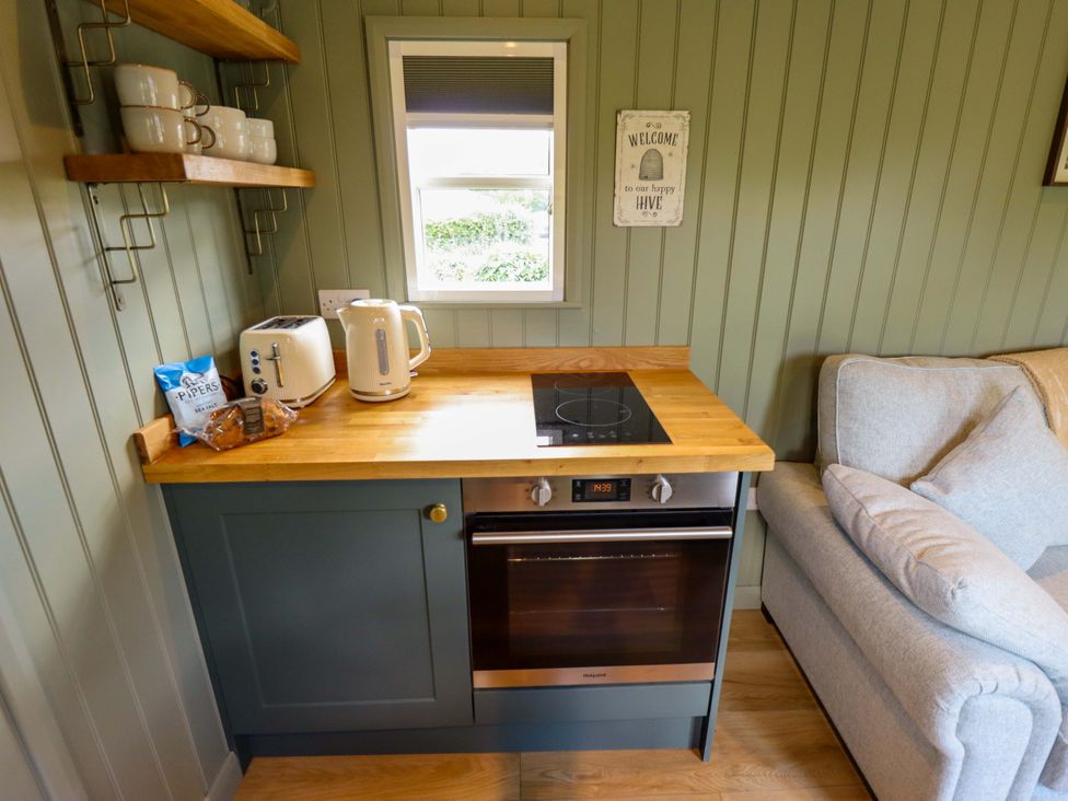 A kitchen with appliances and seating at Bluebell in Grimsby
