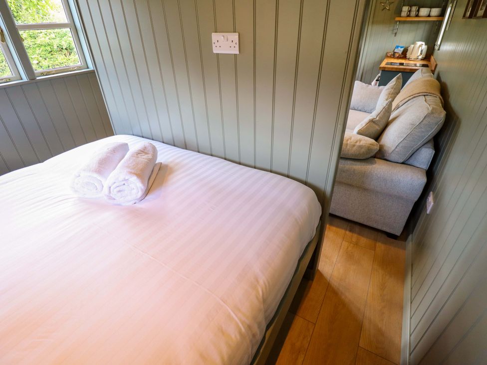 A bedroom with a bed and towels at Bluebell in Grimsby
