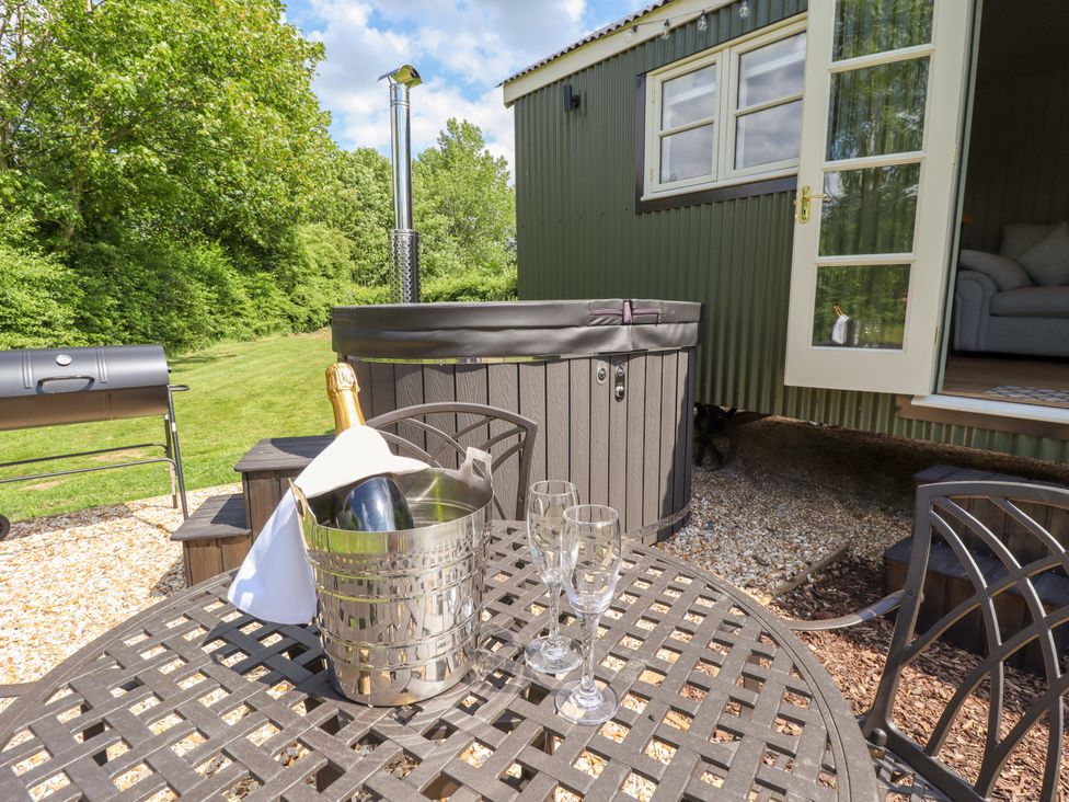 A table with ice bucket and champagne on a patio at Bluebell in Grimsby
