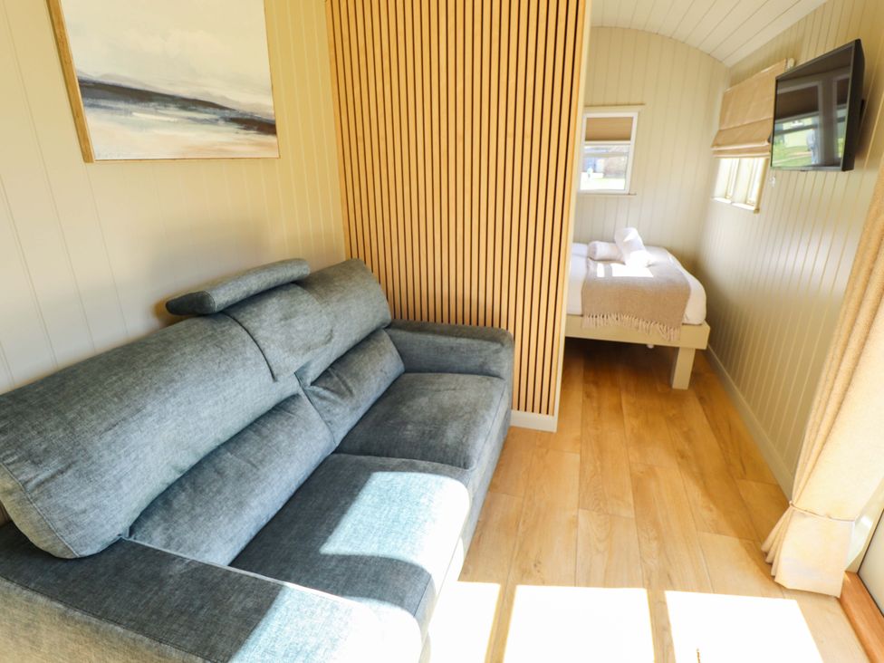 A living room with a sofa and a bed at Magnolia in Grimsby