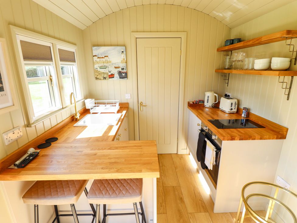 A kitchen with a sink and stove at Magnolia in Grimsby