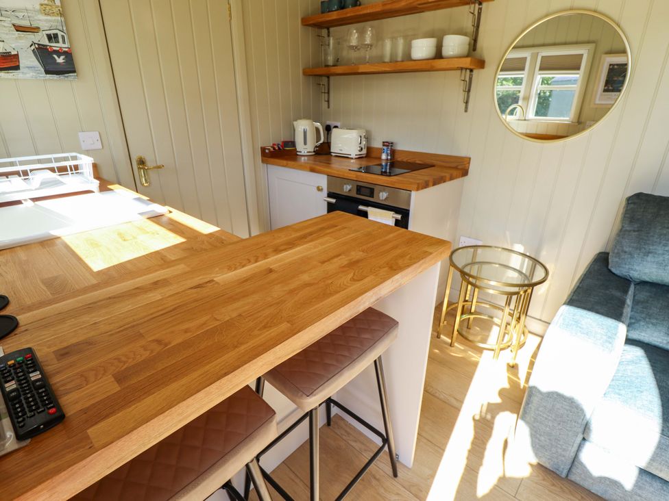 A kitchen with wooden counters and appliances at Magnolia in Grimsby