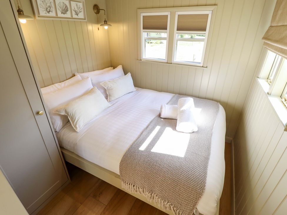 A bedroom with a bed and pillows at Magnolia in Grimsby