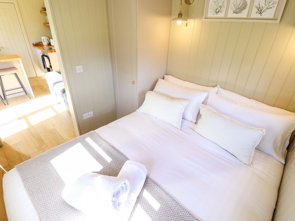 A bedroom with a bed and pillows at Magnolia in Grimsby