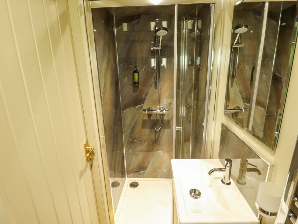 A bathroom with a shower and sink at Magnolia in Grimsby
