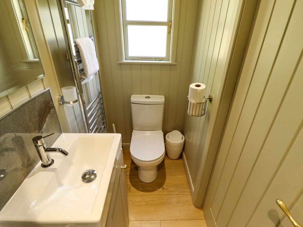 A bathroom with a sink and toilet at Magnolia in Grimsby
