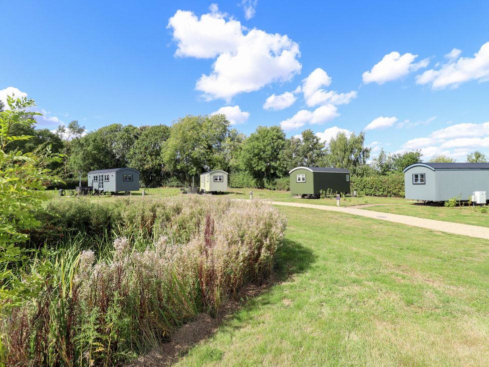 Three huts located in a grassy area at Magnolia in Grimsby