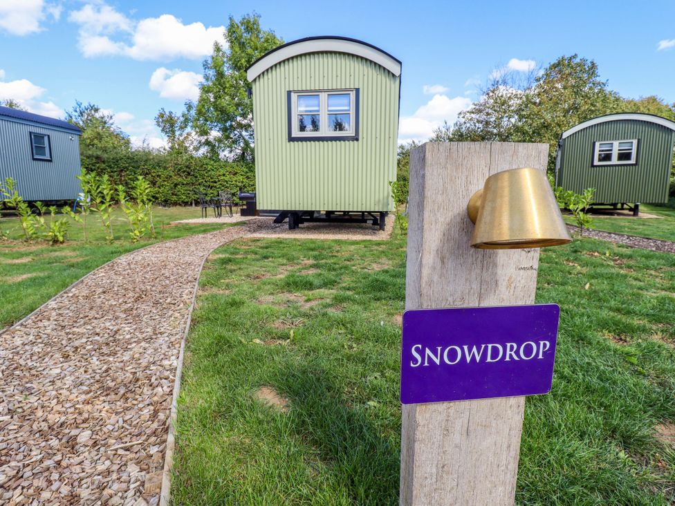 An outdoor area with shepherd's huts and a pathway at Snowdrop in Grimsby
