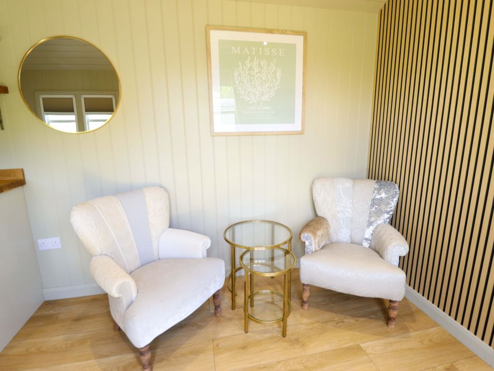 A snug with two chairs and a table at Snowdrop in Grimsby