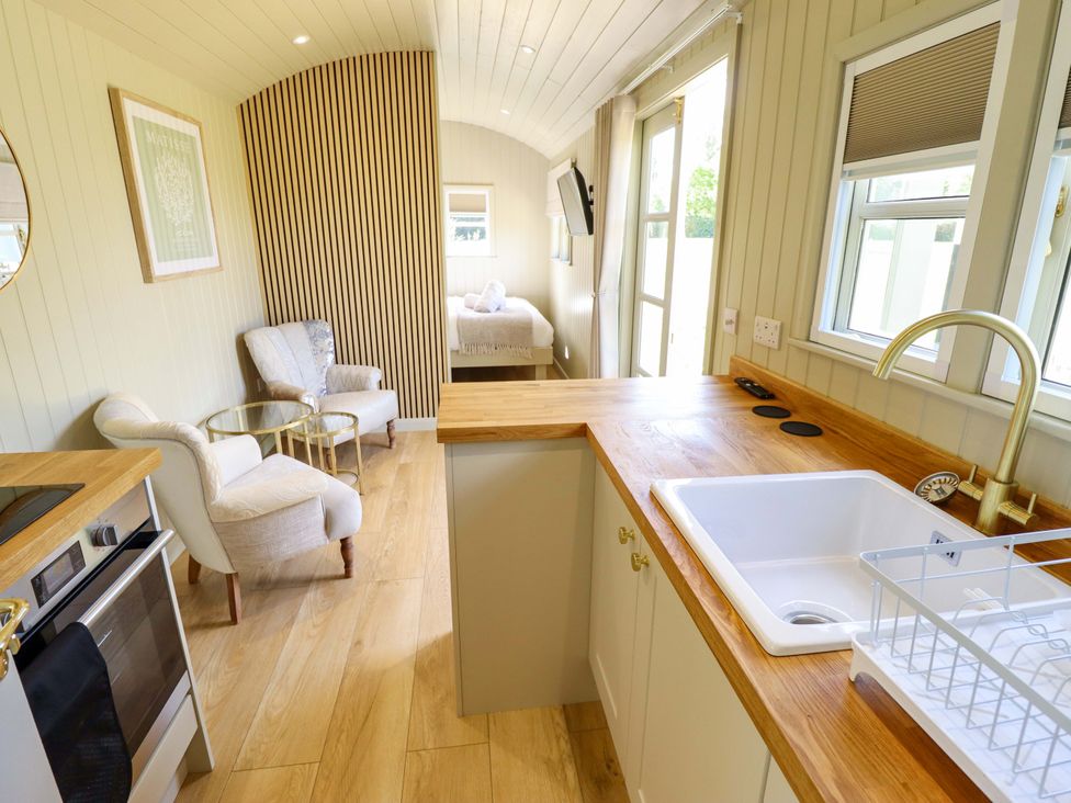 A kitchen with appliances and seating area at Snowdrop in Grimsby