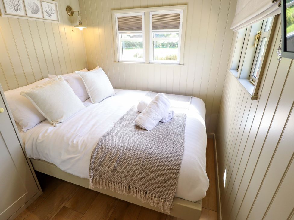 A bedroom with a bed and pillows at Snowdrop in Grimsby