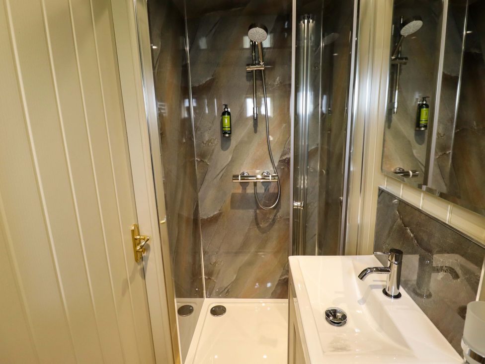 A bathroom with a shower and sink at Snowdrop in Grimsby