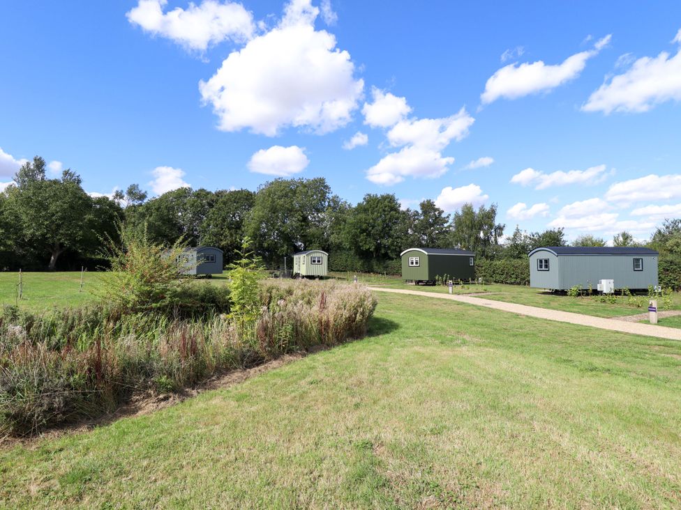 Three huts in a grassy area at Snowdrop in Grimsby