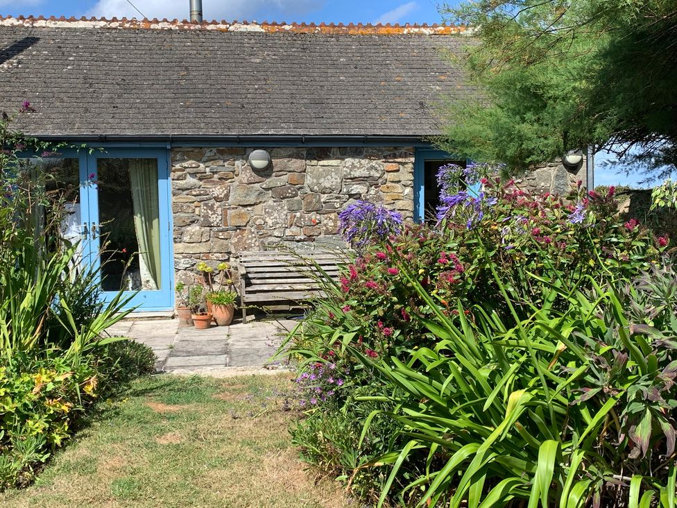 A house with a stone wall and garden at Stargazy Skies near Beacon Drive