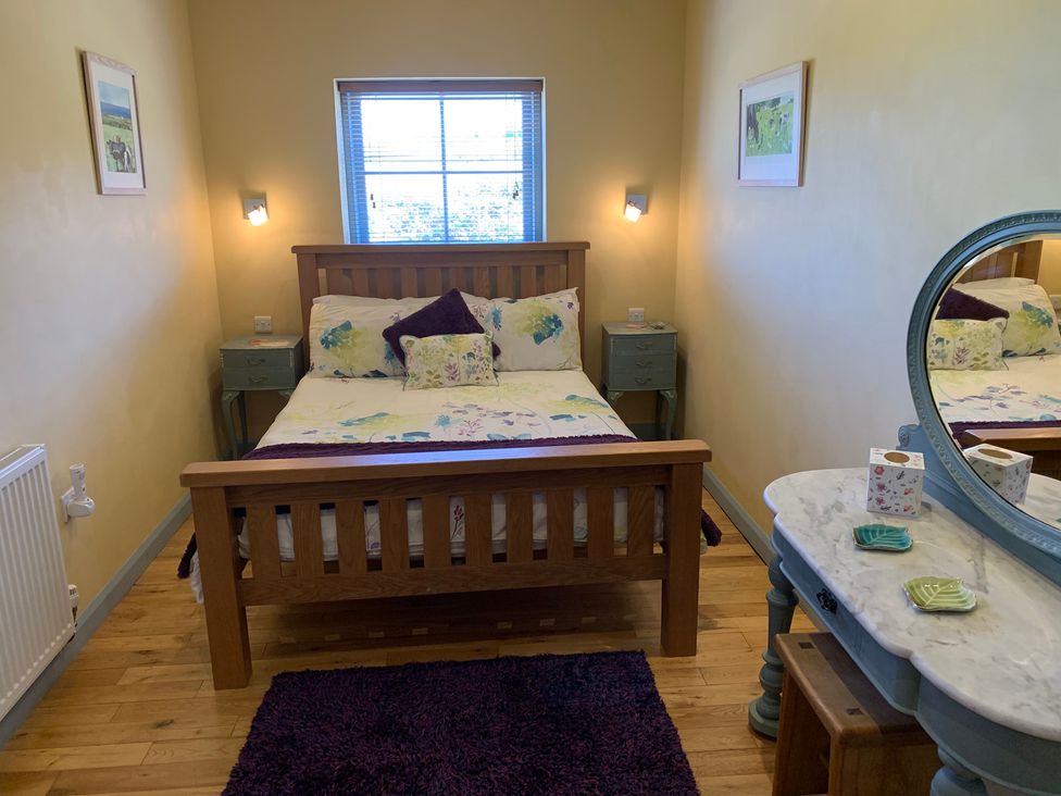 A bedroom with a bed and vanity at Stargazy Skies, Beacon Drive near St Agnes