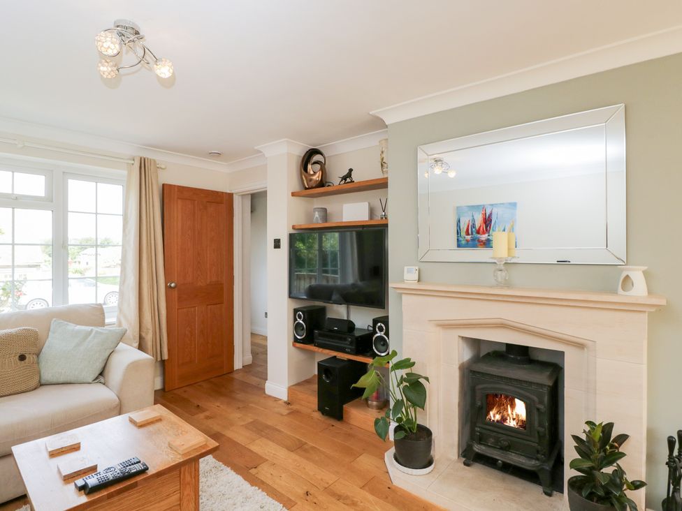 A living room with a sofa table and fireplace at Lorien in Fifield