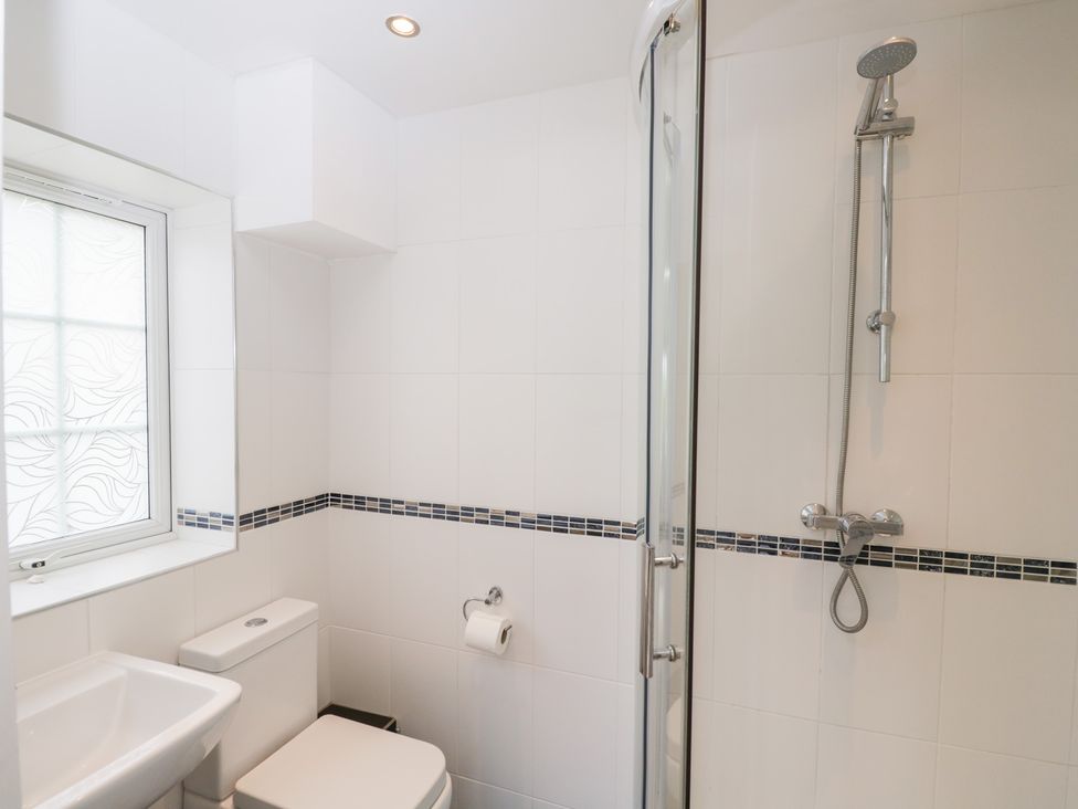 A bathroom with a toilet, sink, and shower at Lorien in Fifield