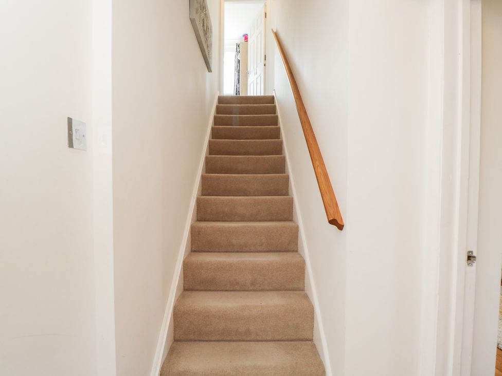 A staircase with a handrail and light switch at Lorien in Fifield