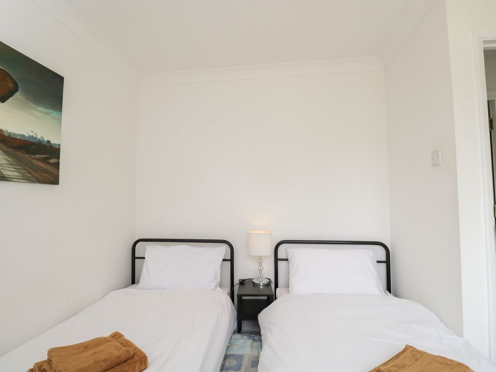 A bedroom with twin beds and a lamp at Lorien in Fifield