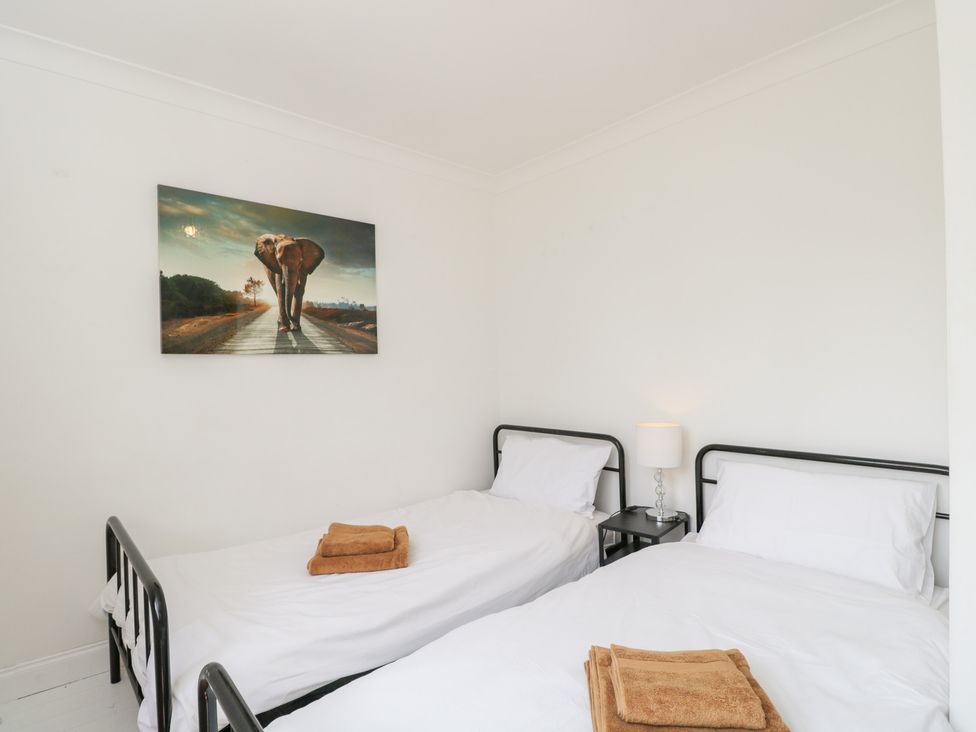 A bedroom with two beds and a lamp at Lorien in Fifield