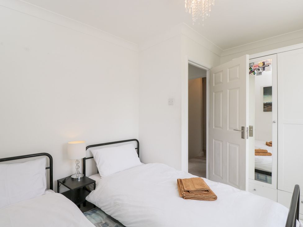 A bedroom with two beds and a wardrobe at Lorien in Fifield