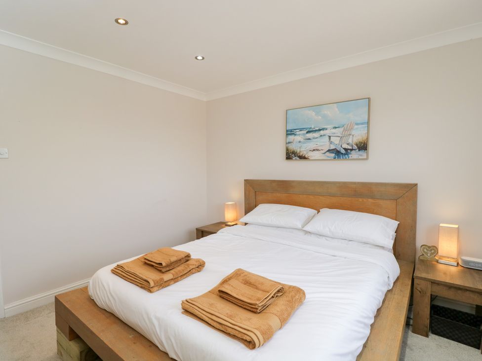 A bedroom with a bed and towels on top at Lorien in Fifield