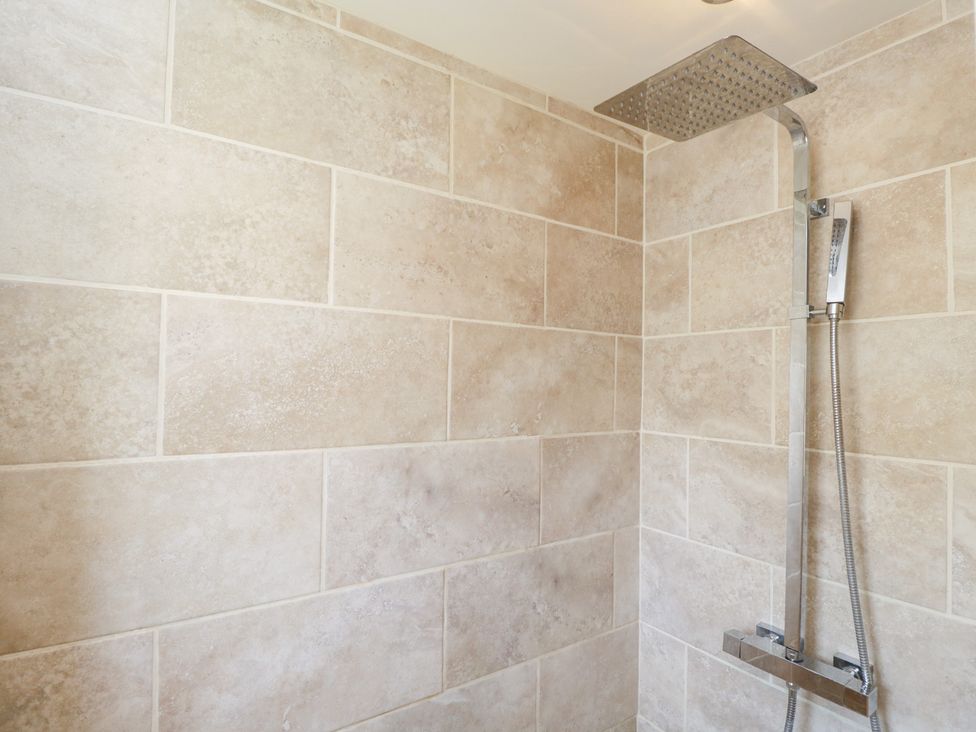 A shower with tiled walls and fixtures at Lorien in Fifield
