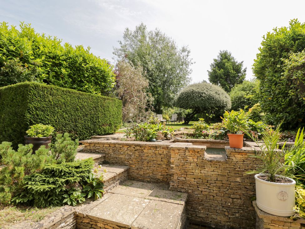 A garden with stone wall and steps at Lorien in Fifield