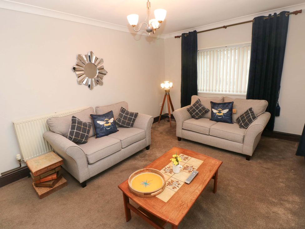 A living room with two couches and a coffee table at Graig Goch Burry Port