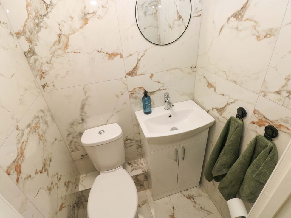A bathroom with a toilet and sink at Graig Goch in Burry Port