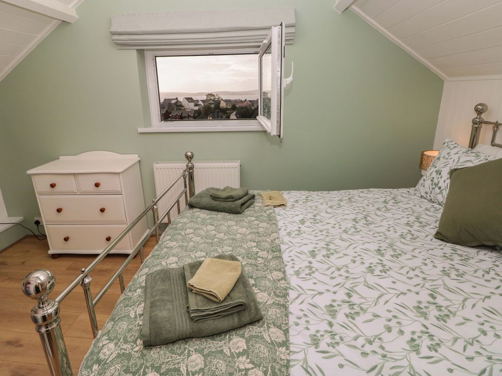 A bedroom with a bed and chest of drawers at Graig Goch in Burry Port