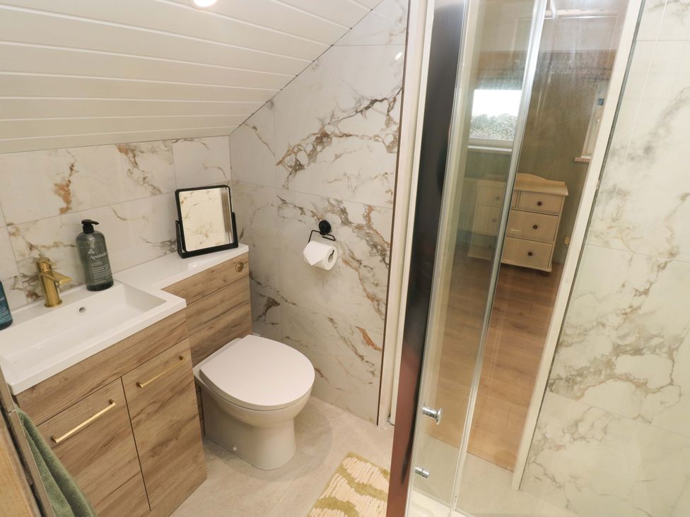 A bathroom with sink toilet and shower at Graig Goch in Burry Port