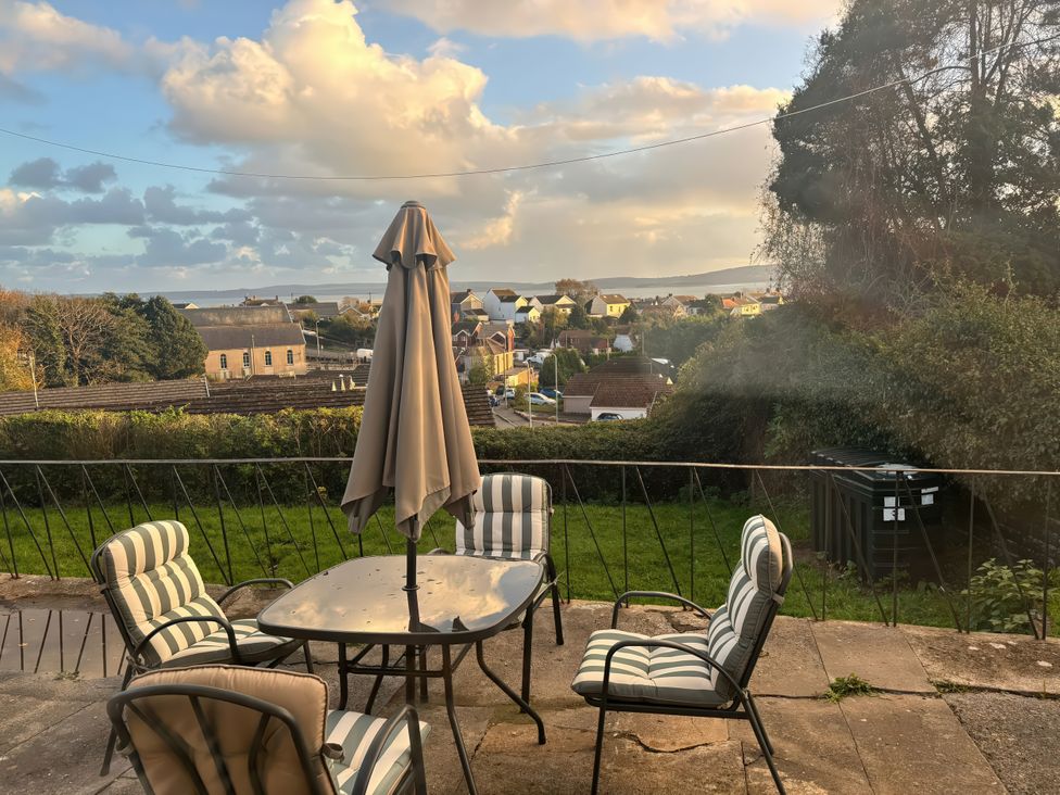 An outdoor seating area with a table and chairs at Graig Goch in Burry Port