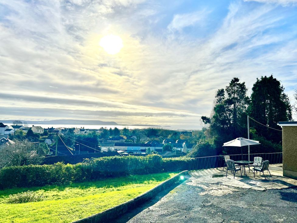 An outdoor view with sun, sky, and landscape at Graig Goch in Burry Port