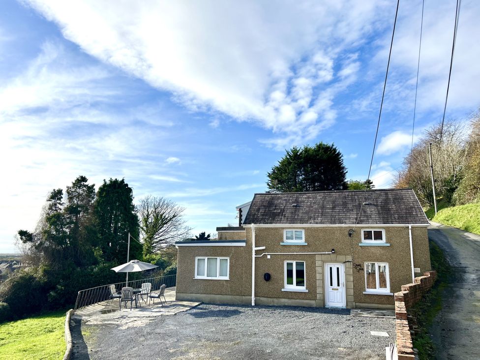 A house with a patio and garden area at Graig Goch in Burry Port