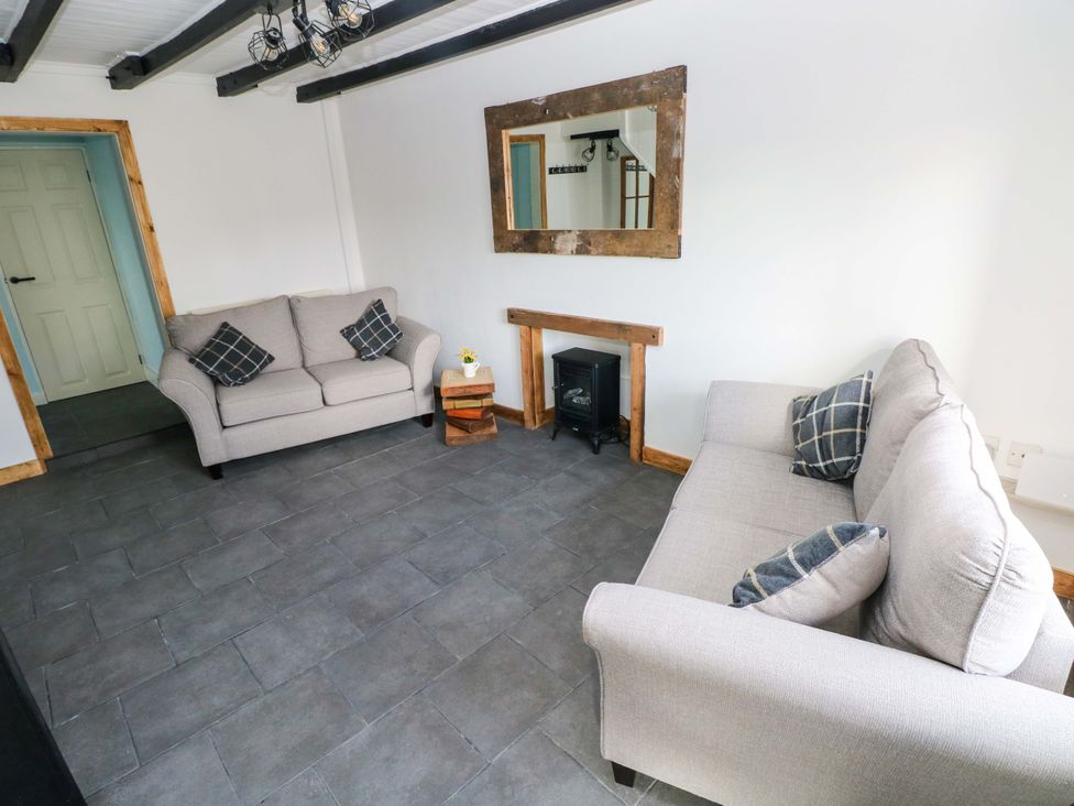 A living room with two sofas and a fireplace at Graig Goch in Burry Port