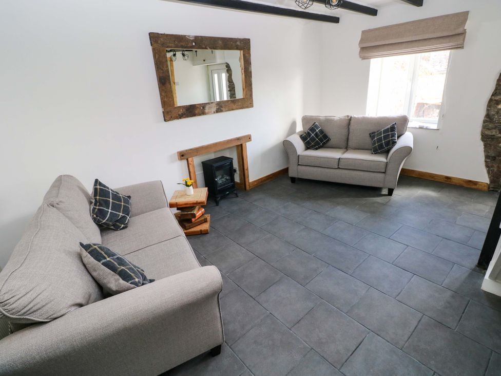 A living room with two sofas and a fireplace at Graig Goch in Burry Port