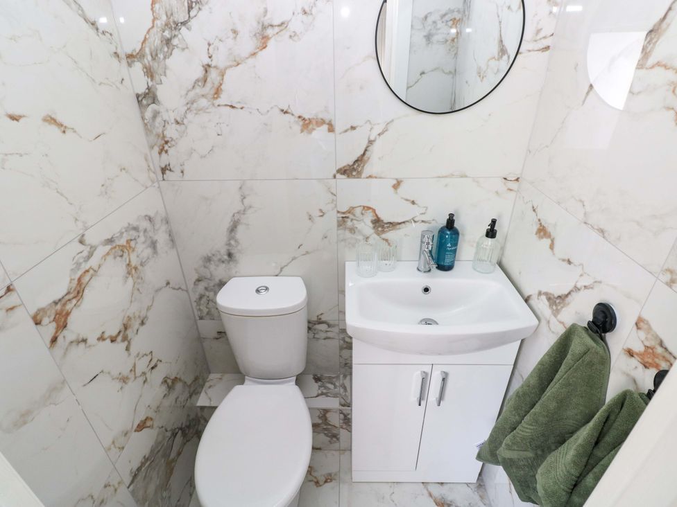 A bathroom with a toilet and sink at Graig Goch in Burry Port