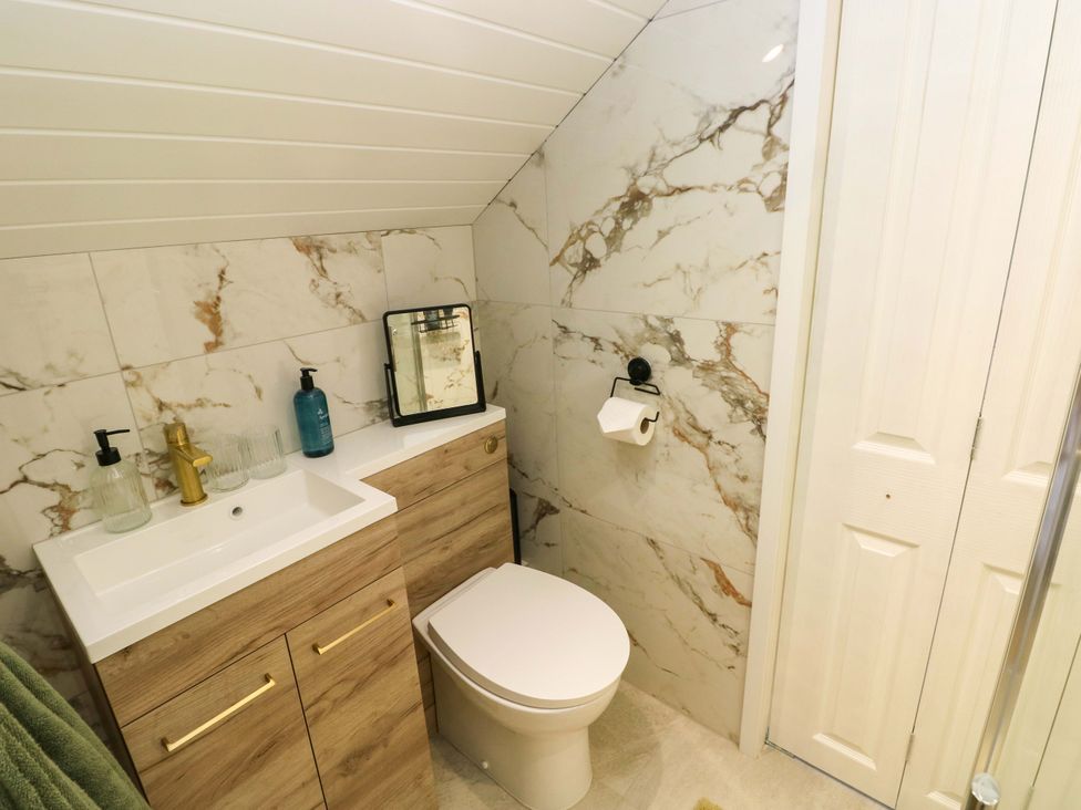 A bathroom with a sink and toilet at Graig Goch in Burry Port