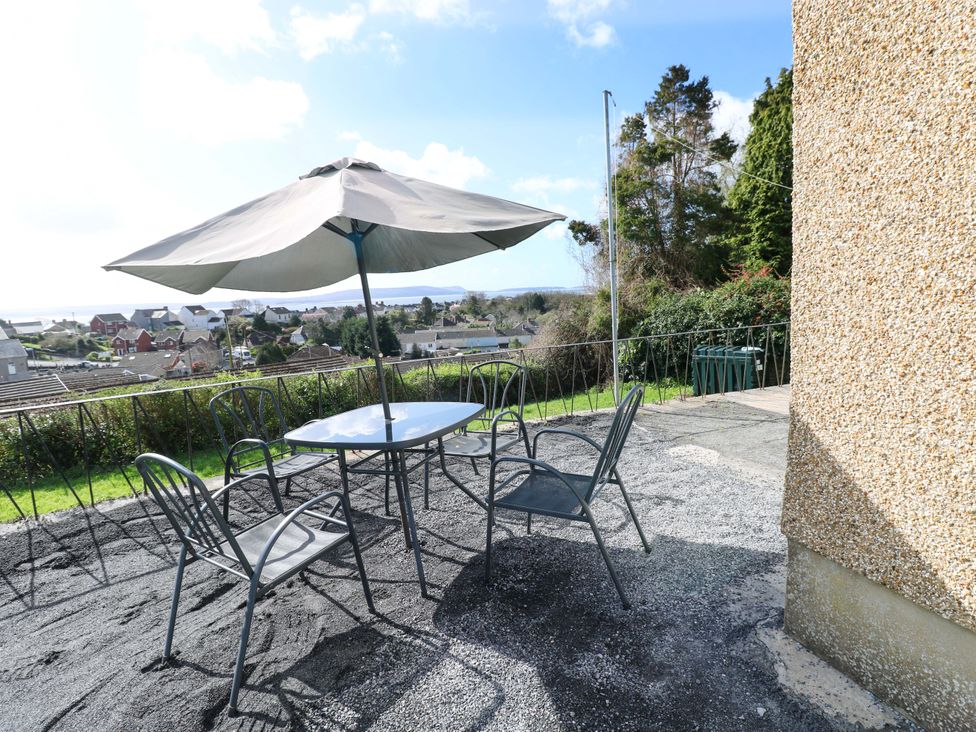 An outdoor seating area with a table and chairs at Graig Goch in Burry Port
