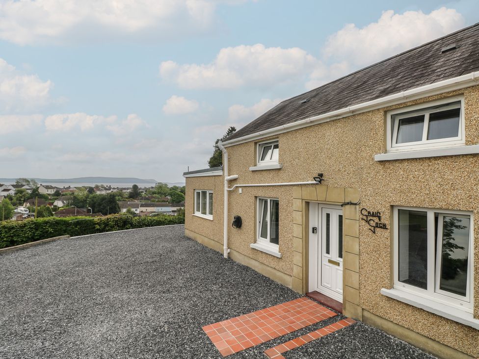 A house with a gravel driveway and a front door at Graig Goch in Burry Port
