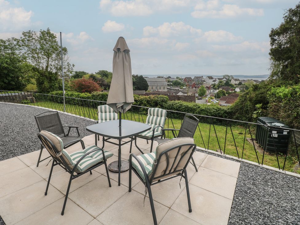 An outdoor seating area with a table and chairs at Graig Goch in Burry Port