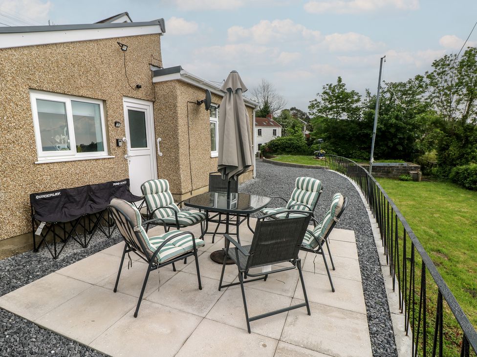 An outdoor seating area with a table and chairs at Graig Goch in Burry Port