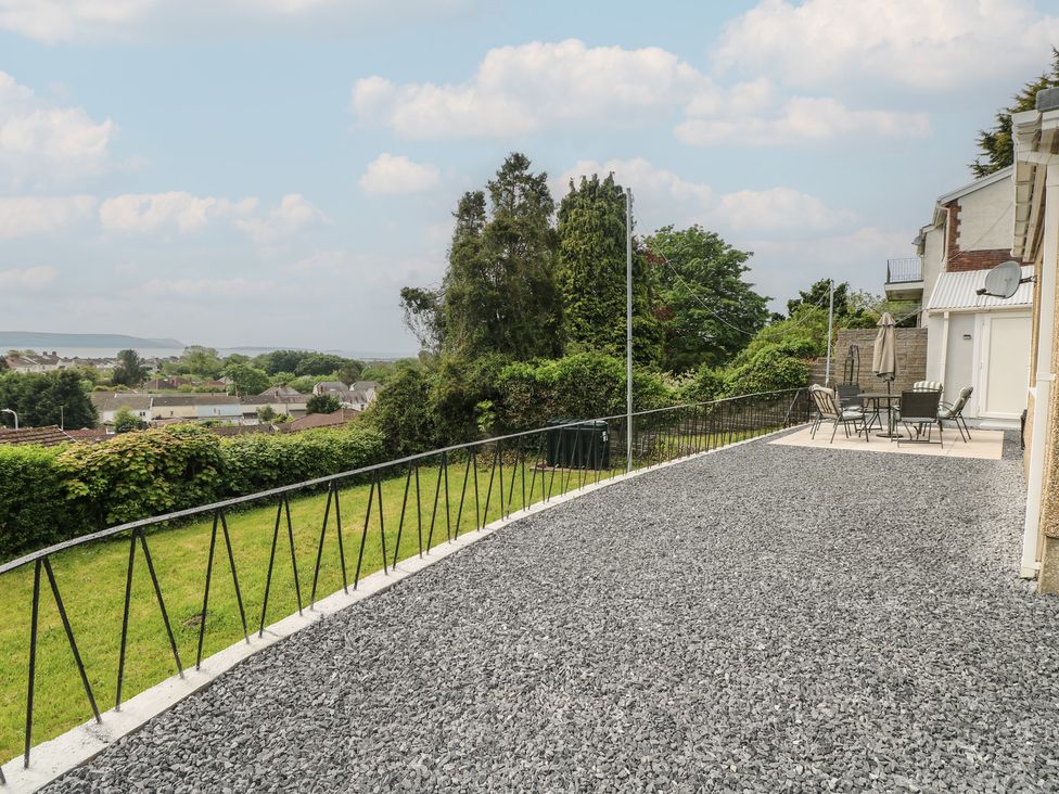 An outdoor area with a gravel surface and patio furniture at Graig Goch in Burry Port