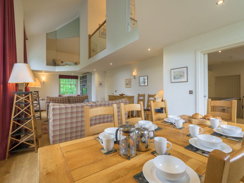 A dining room with a wooden table set for breakfast at The School in Mungrisdale near Caldbeck
