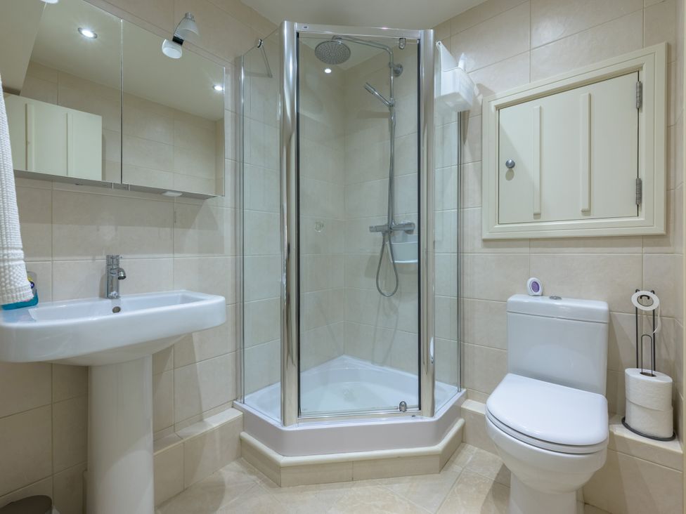 A bathroom with a shower, toilet, and sink at The School in Mungrisdale near Caldbeck