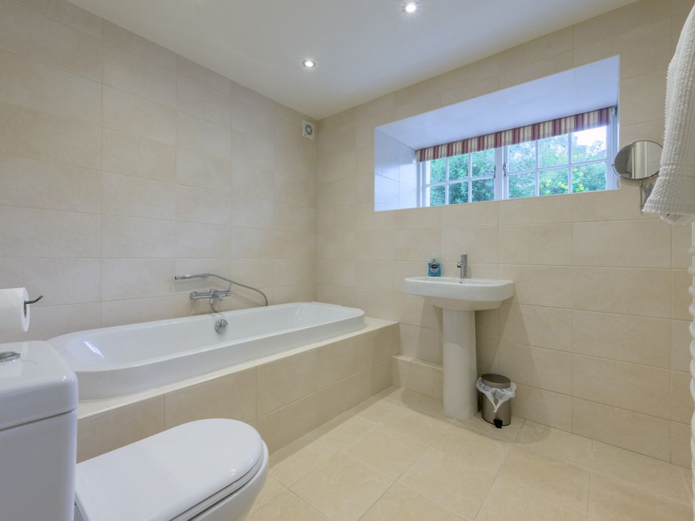 A bathroom with a bath tub and sink at The School in Mungrisdale near Caldbeck
