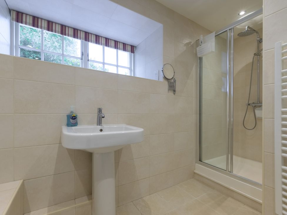 A bathroom featuring a shower and sink at The School in Mungrisdale near Caldbeck