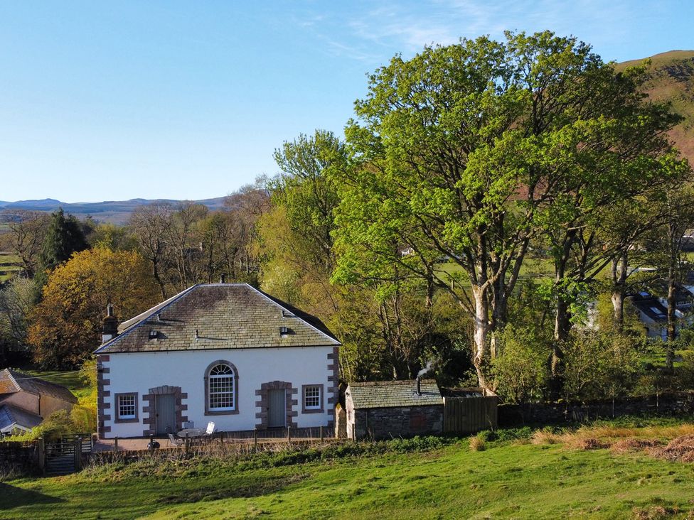 A building with trees and grass at The School at Mungrisdale near Keswick