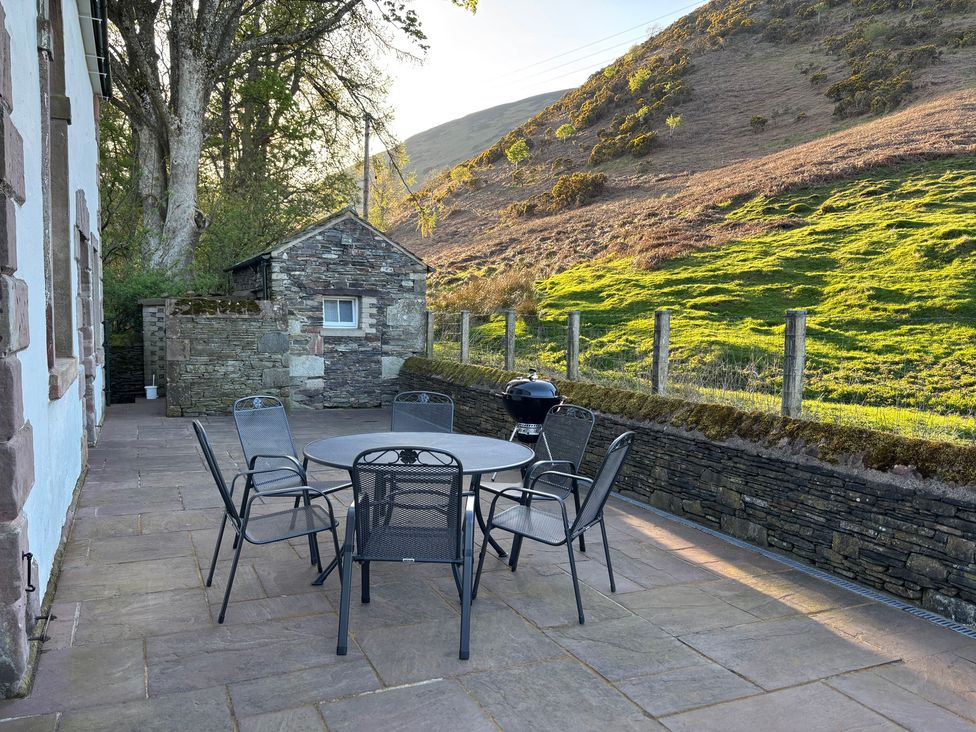A patio area with a table and chairs at The School at Mungrisdale near Keswick
